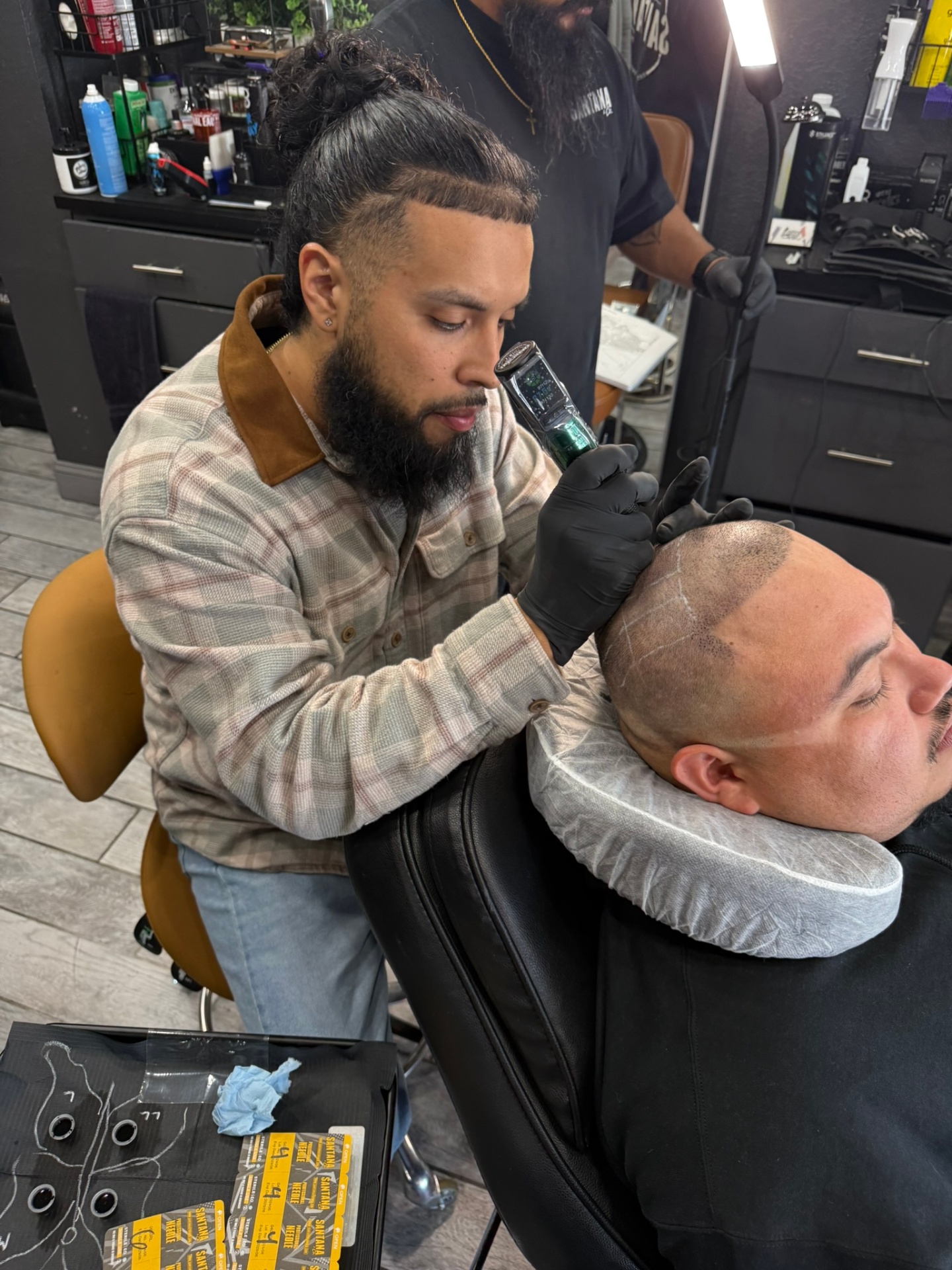 Barber performing scalp micro pigmentation tattoo